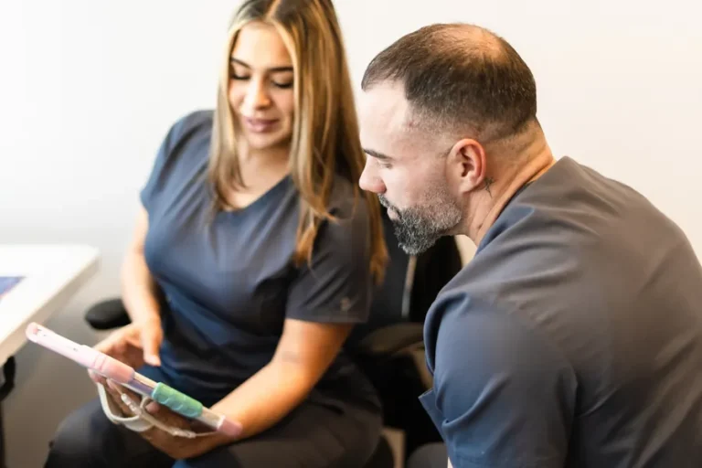 FTG Ortho team members reviewing a patient treatment plan on a tablet
