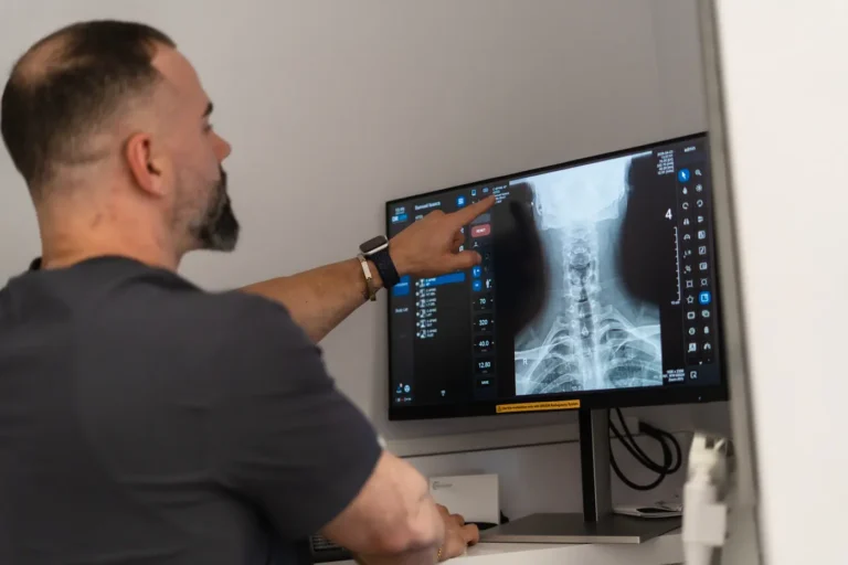 Orthopedic clinician pointing to an X-ray while reviewing treatment options