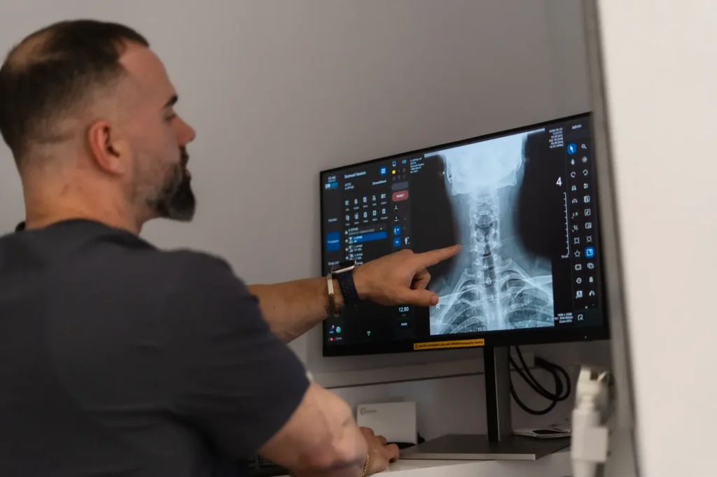 FTG Ortho clinician reviewing spine X-ray results on screen