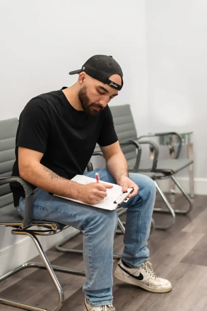 Patient completing workers' compensation paperwork at FTG Ortho